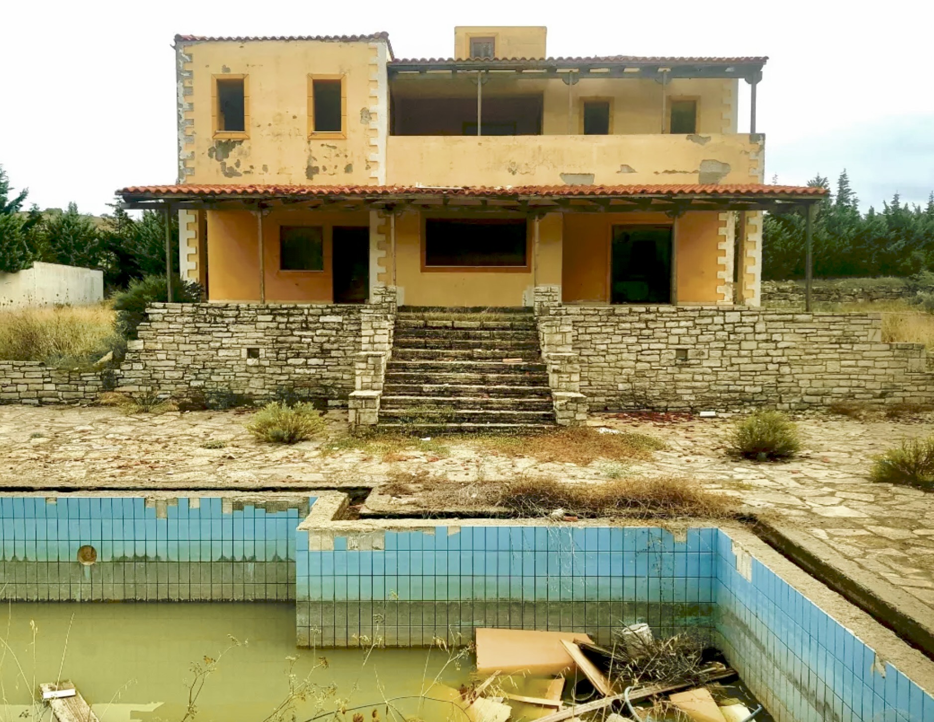 Abandoned Villa and Pool, surrounded in pomegranate trees